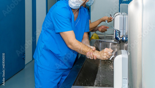 A team of surgeons wash their hands before surgery. Selective focus. Hospital concept.