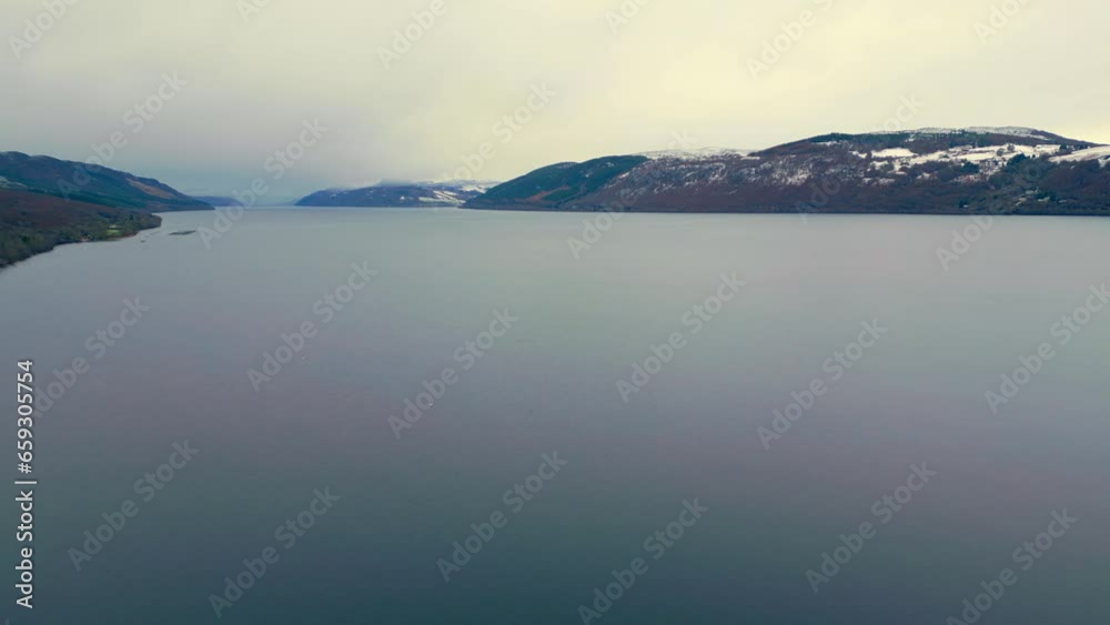 Aerial panoramic view of majestic area of Loch Ness lake. Snow dusted hills around water surface. Scotland, UK Aerial panoramic view of majestic area of Loch Ness lake. Snow dusted hills around water surface. Scotland, UK