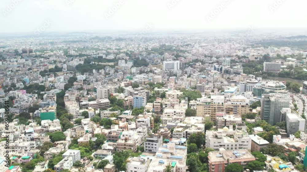 South Indian city seen from the air moving towards a major road in the middle of the city. Buildings are under bright afternoon. South Indian city seen from the air moving towards a major road in the middle of the city. Buildings are under bright afternoon.