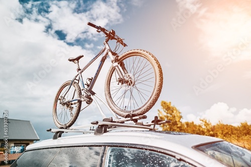 Car Roof Bicycle Mount for Adventurous Travel. Top roof bicycle mount. Concept of transporting a bicycle.