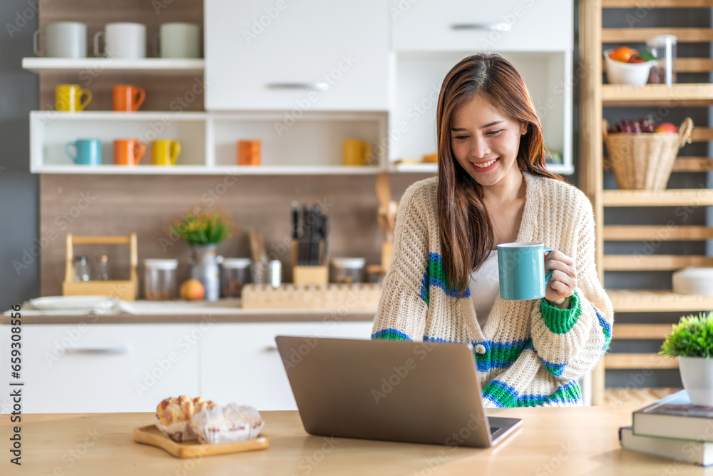 Young smiling asian woman happy relax use laptop conference work,learning education, shopping, study online, webinar, podcast,creative girl feel good, positive, success, drink coffee at home Young smiling asian woman happy relax use laptop conference work,learning education, shopping, study online, webinar, podcast,creative girl feel good, positive, success, drink coffee at home