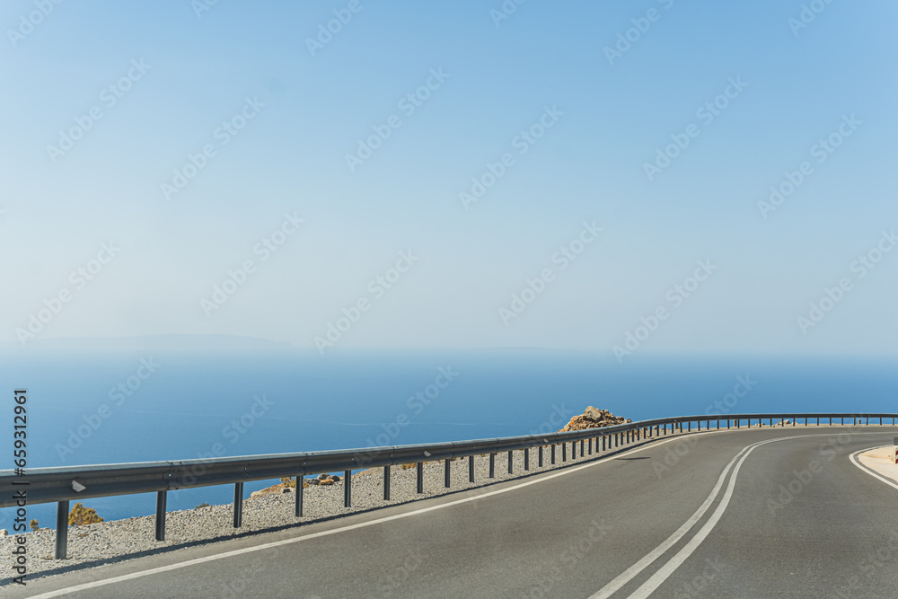 breathtaking view of a winding road and blue crystal water on Crete south coast, Greek. High quality photo