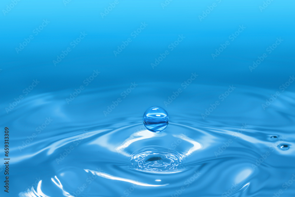 Clear aqua water droplet splashing in concentric circles, capturing refreshing purity.