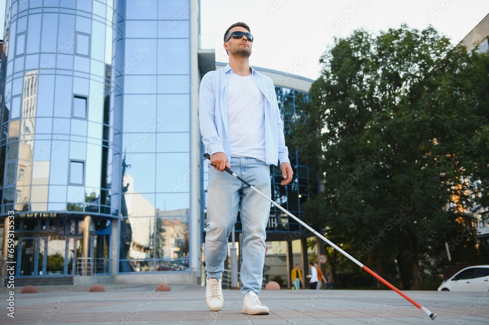 Blind man. Visually impaired man with walking stick,