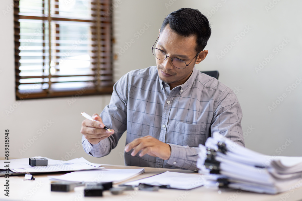 Serious and focused financier accountant on paper work inside office, mature business asian man using calculator and laptop for calculating reports and summarizing accounts, Serious and focused financier accountant on paper work inside office, mature business asian man using calculator and laptop for calculating reports and summarizing accounts,