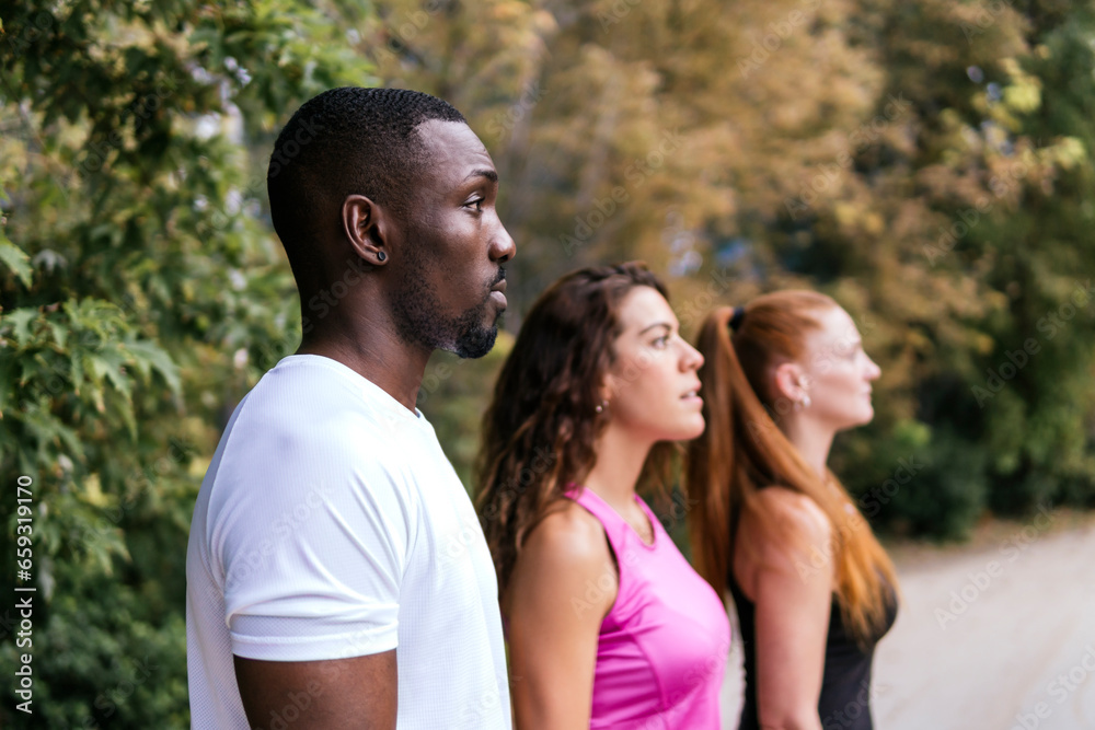 Multiracial friends contemplating together at park Multiracial friends contemplating together at park