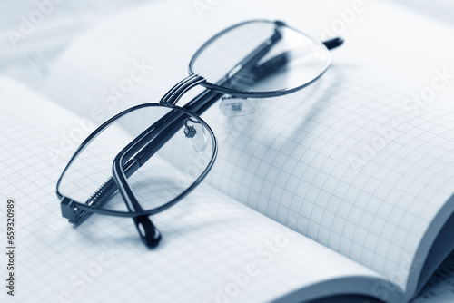 Close up of eye glasses on a business document.