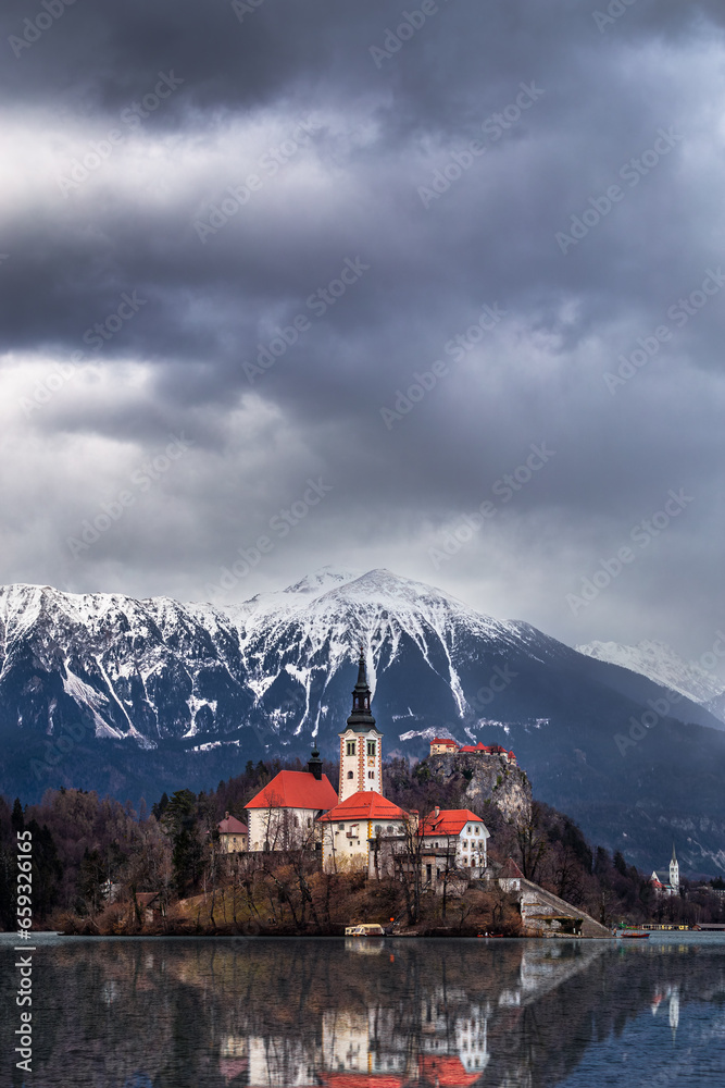Bled, Slovenia - Beautiful view of Lake Bled (Blejsko Jezero) with reflecting Pilgrimage Church of the Assumption of Maria on Bled Island, Bled Castle and Julian Alps at background at winter time 
