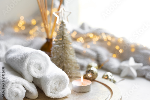 Christmas spa composition on a blurred background with bokeh lights.