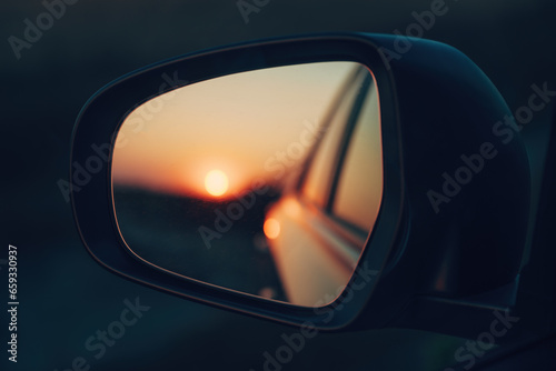 Sunset sky seen in the car's wing mirror