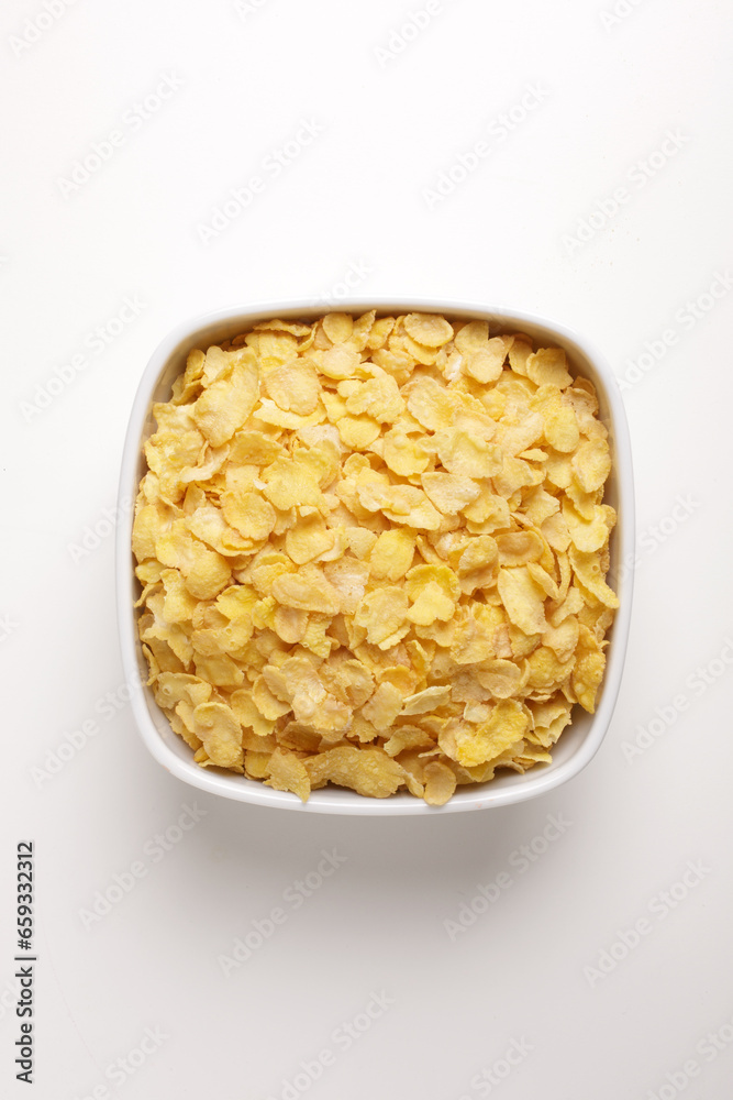 corn flakes in a square plate on a white background taken from above