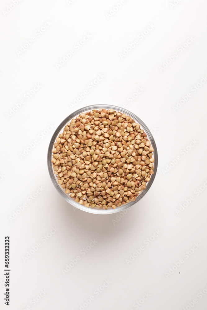 buckwheat in glass bowl on white background shot from above buckwheat in glass bowl on white background shot from above