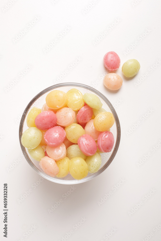 candies in glass bowl on white background shot from above candies in glass bowl on white background shot from above