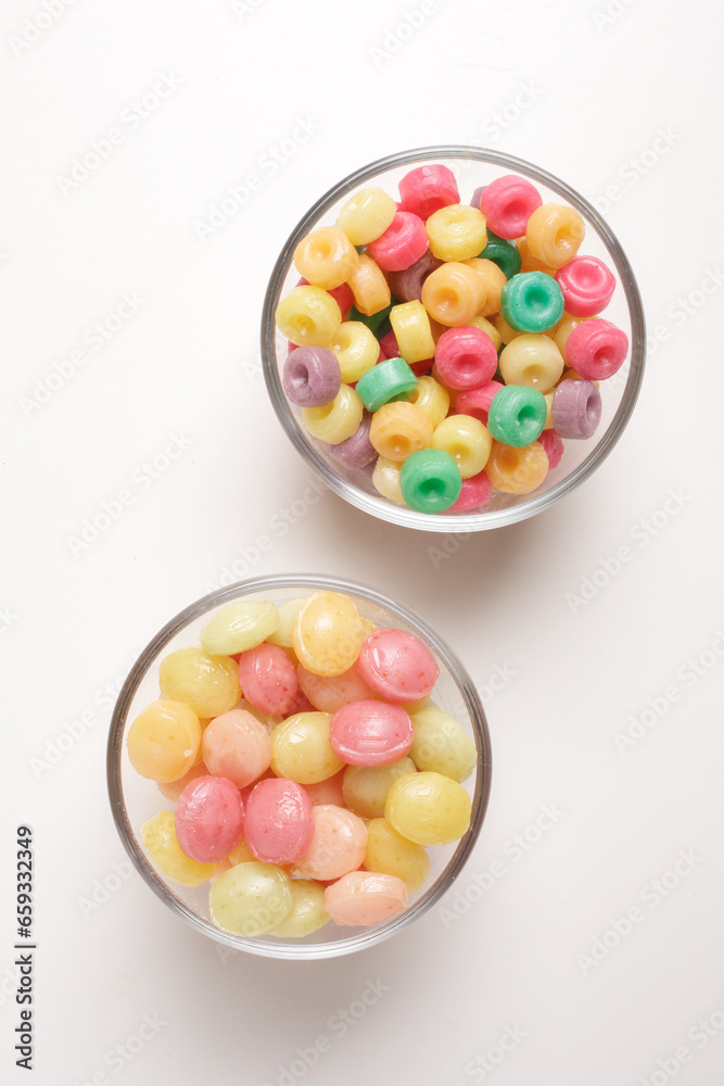 candies in glass bowl on white background shot from above