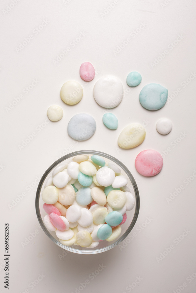 candies in glass bowl on white background shot from above candies in glass bowl on white background shot from above