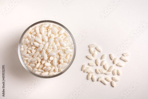puffed rice in glass bowl on white background taken from above