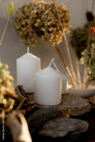 Decoration with dry flowers and hydrangea. candles, stones. Stones for decoration photo