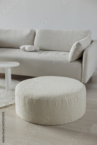 Bouclé pouf in white minimalist design. White sofa