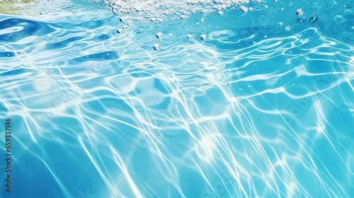 Clear water surface with ripple wave splashes and drops in swimming pool. Abstract turquoise or blue texture water wave and sunlight shadow reflections for background