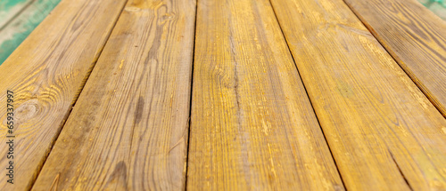 Old wooden boards painted with yellow paint. Background