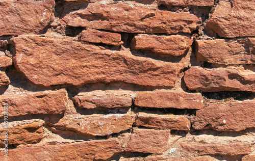 Ancient stone bricks in the wall as a background. Texture