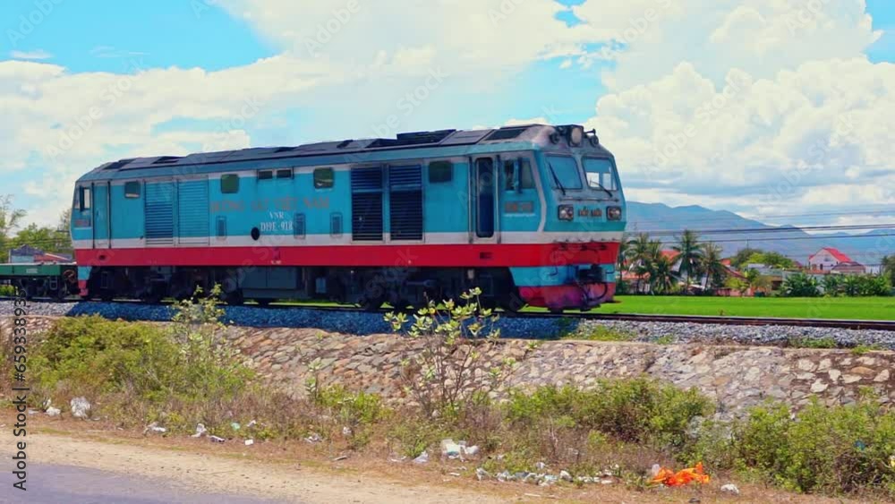 Train running on ancient railway Vietnam passes through countryside in Phan Rang. The train transports passengers and goods from North to South and vice versa, helping to develop economy in Vietnam. Train running on ancient railway Vietnam passes through countryside in Phan Rang. The train transports passengers and goods from North to South and vice versa, helping to develop economy in Vietnam.