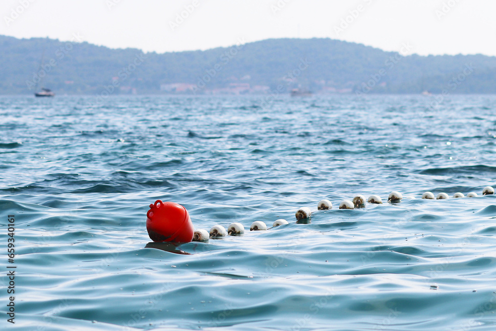 The sea water area is intended for bathing holidaymakers fenced with buoys for safety. Rest on the water in the early morning. Sun rays during the holidays. Arrangement of beaches and reservoirs The sea water area is intended for bathing holidaymakers fenced with buoys for safety. Rest on the water in the early morning. Sun rays during the holidays. Arrangement of beaches and reservoirs