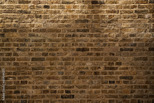 Building exterior, roughly textured brown brick wall background