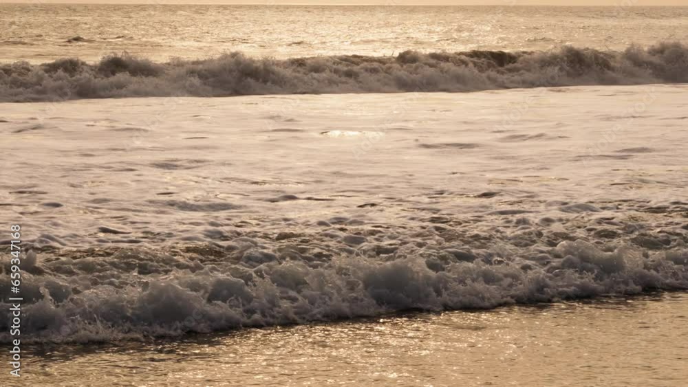 Slowmotion small sea water waves come to sand beach Bali Indonesia close up tele Slowmotion small sea water waves come to sand beach Bali Indonesia close up tele