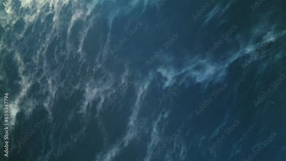 Shot from above down to the surface of the river with clouds of evaporated water floating above