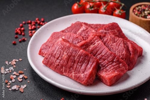 Fresh juicy raw beef slices with salt and spices