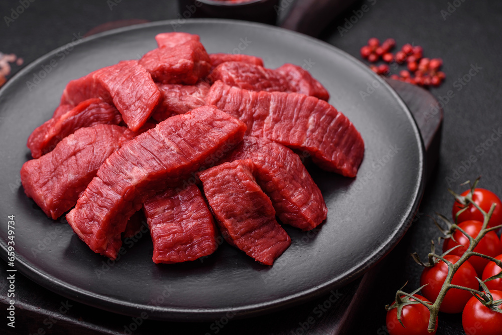 Fresh juicy raw beef slices with salt and spices