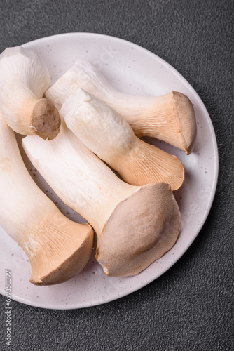 Pleurotus eryngii mushrooms on a dark concrete background