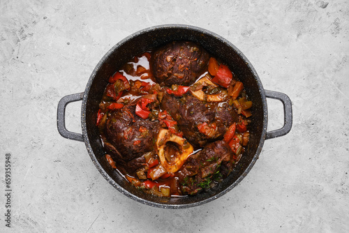 Top view of prepared beef ossobuco with vegetables in a casserole