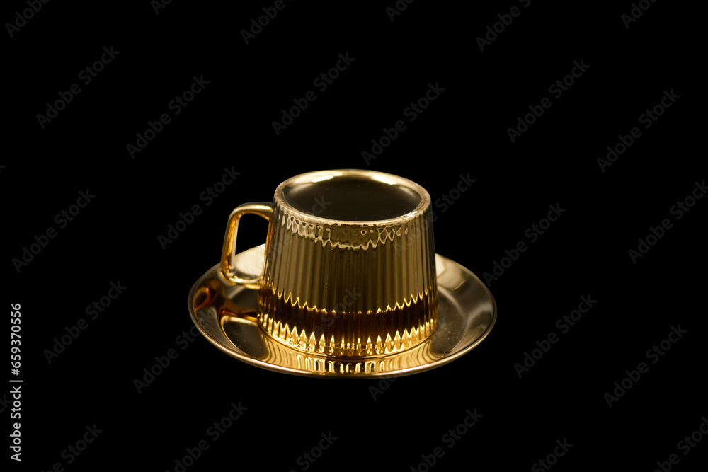 Expensive Golden tea cup and saucer on black backgroound. Expensive Golden tea cup and saucer on black backgroound.