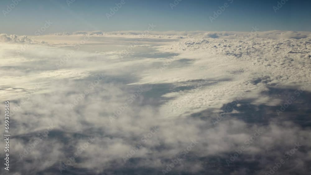 Aerial, view of planet earth from spaceship. Looking down on clouds during sunset with sunlight shining on top of clouds on earth from space ship orbiting earth in cinematic slow motion. Aerial, view of planet earth from spaceship. Looking down on clouds during sunset with sunlight shining on top of clouds on earth from space ship orbiting earth in cinematic slow motion.