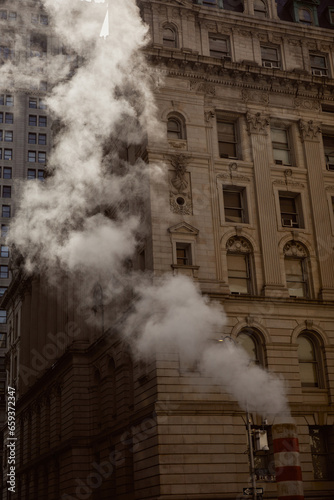 steam pipe and vintage building on street in downtown of new york city, metropolis atmosphere
