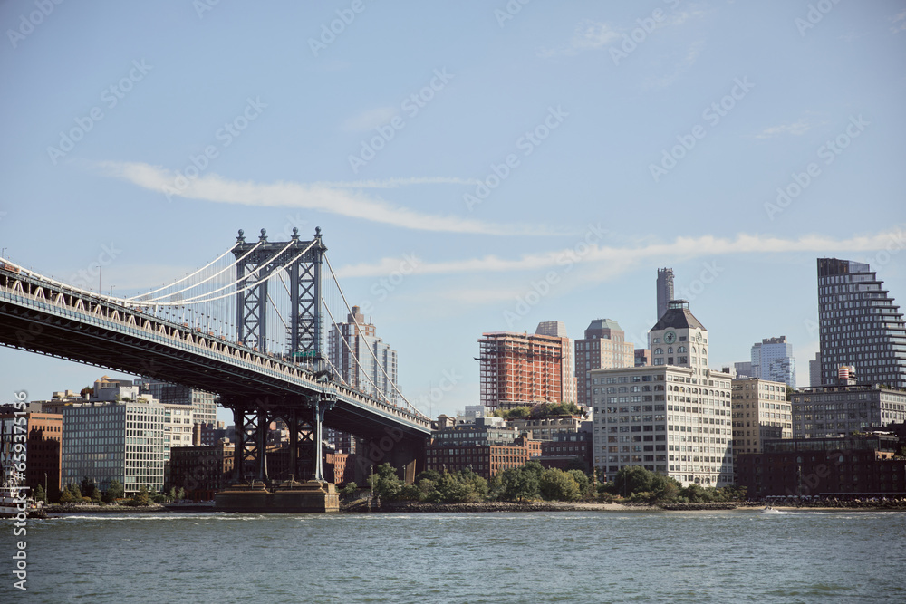 Manhattan bridge over east river and picturesque new york cityscape with modern skyscrapers