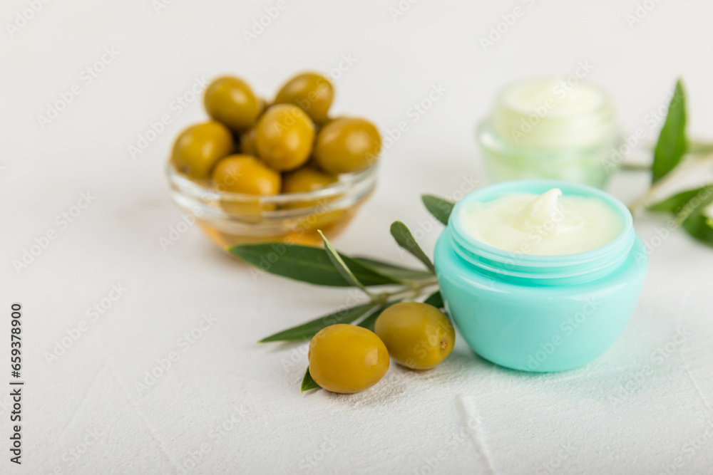 Jar of natural olive cream with olive oil extract on a texture background. Cosmetic tube. Moisturizing cosmetic cream for skin. Body care. Beauty concept. Copy space. Flat lay. Hand cream. Jar of natural olive cream with olive oil extract on a texture background. Cosmetic tube. Moisturizing cosmetic cream for skin. Body care. Beauty concept. Copy space. Flat lay. Hand cream.