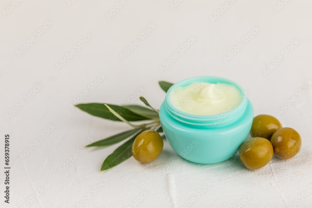 Jar of natural olive cream with olive oil extract on a texture background. Cosmetic tube. Moisturizing cosmetic cream for skin. Body care. Beauty concept. Copy space. Flat lay. Hand cream. Jar of natural olive cream with olive oil extract on a texture background. Cosmetic tube. Moisturizing cosmetic cream for skin. Body care. Beauty concept. Copy space. Flat lay. Hand cream.