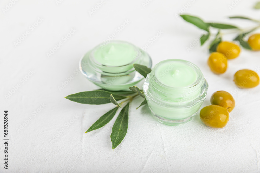 Jar of natural olive cream with olive oil extract on a texture background. Cosmetic tube. Moisturizing cosmetic cream for skin. Body care. Beauty concept. Copy space. Flat lay. Hand cream. Jar of natural olive cream with olive oil extract on a texture background. Cosmetic tube. Moisturizing cosmetic cream for skin. Body care. Beauty concept. Copy space. Flat lay. Hand cream.