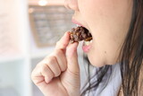Close-up view of mouth eating food, Close-up view of mouth eating chocolate