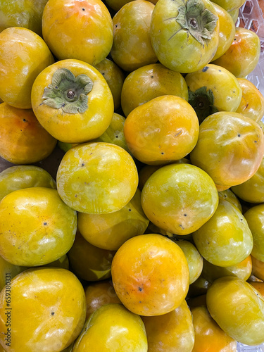 Sweet persimmons in the market, close-up,