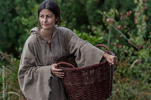 Young medieval peasant woman with basket
