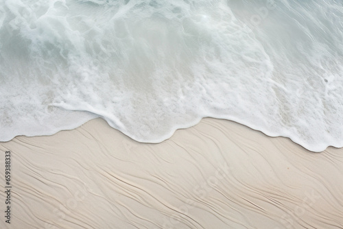 Rippled sand and sea foam, showcasing its softness and beauty in the coastal environment.
