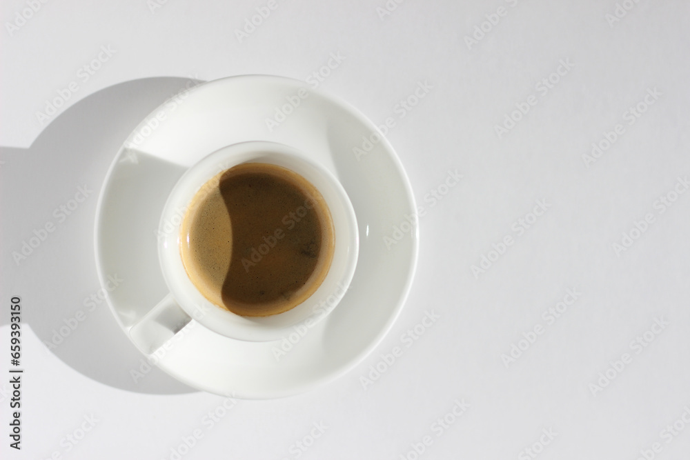 Freshly Brewed Espresso in White Ceramic Cup on White Background with Right Copy Space. Freshly Brewed Espresso in White Ceramic Cup on White Background with Right Copy Space.