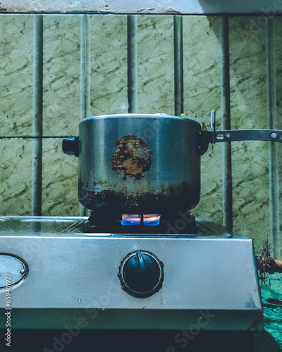 Obraz na plátně Old vintage pressure cooker on the oven at a kitchen in Bhubaneswar, Odisha, India in February 2023