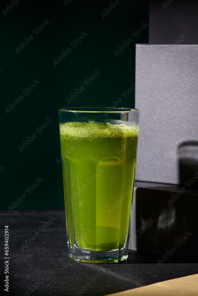 Refreshing green lemonade with basil served in a highball glass, highlighted against a dramatic black background, embodying a healthy lifestyle choice Refreshing green lemonade with basil served in a highball glass, highlighted against a dramatic black background, embodying a healthy lifestyle choice