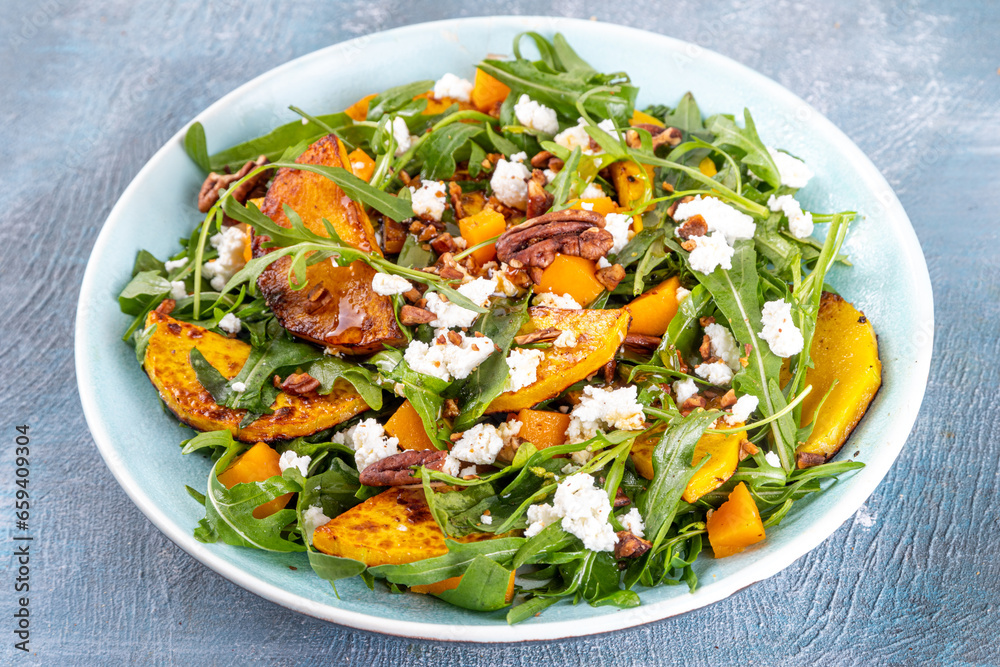 Autumn warm salad. Homemade fall season salad with grill and baked pumpkin, arugula, feta cheese and crushed nuts, Whole vegan paleo fruit and vegetable salad idea. Autumn warm salad. Homemade fall season salad with grill and baked pumpkin, arugula, feta cheese and crushed nuts, Whole vegan paleo fruit and vegetable salad idea.