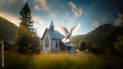 Holy Spirit, winged dove, flying over an old church in the mountains photo